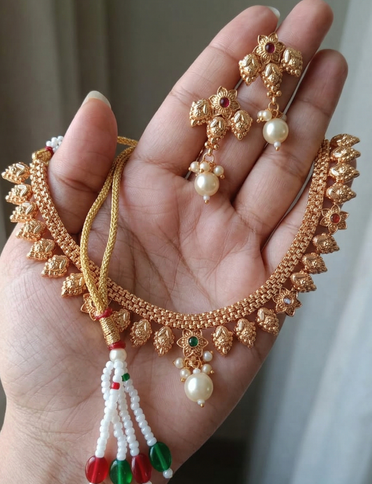 Close-up view of premium artificial Traditional Matte Gold Plated Temple Jewellery Necklace Set with Earrings for Women by Innovate Art Impex.