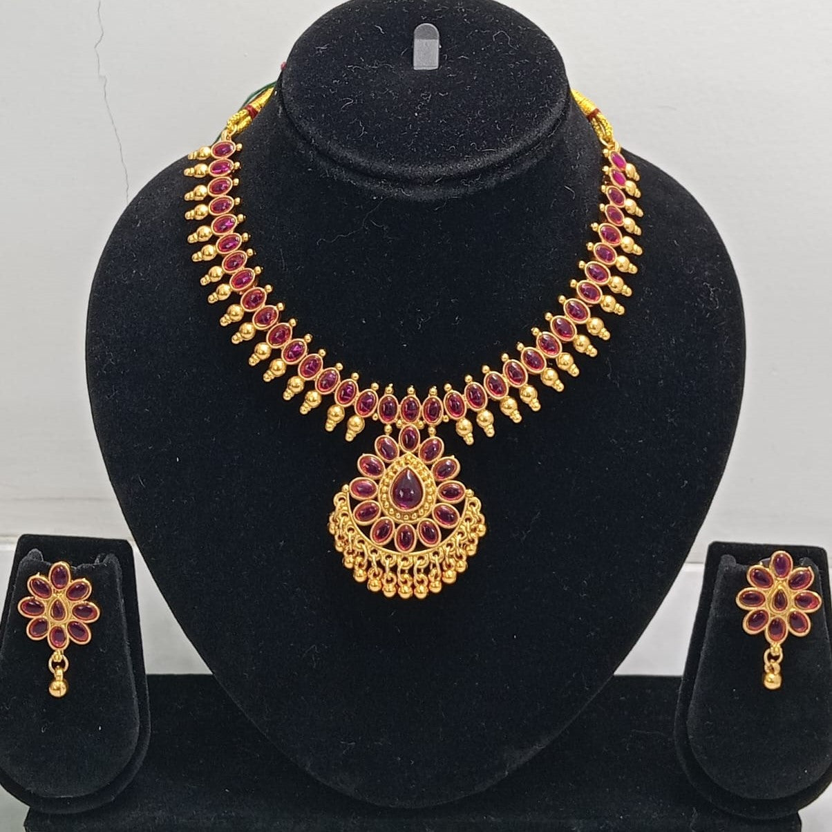 Close-up view of premium artificial Gold Plated Ruby Red Stone Traditional Necklace Set with Matching Earrings for Women by Innovate Art Impex.