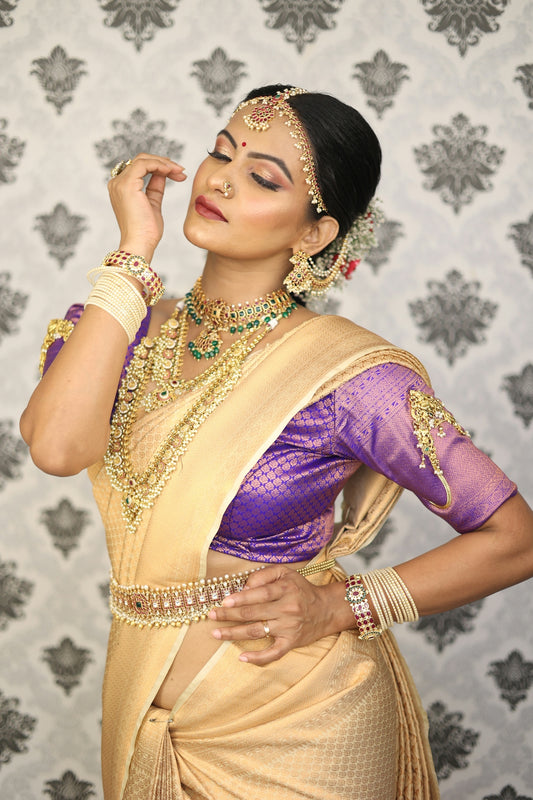 A woman poses in traditional indian attire.