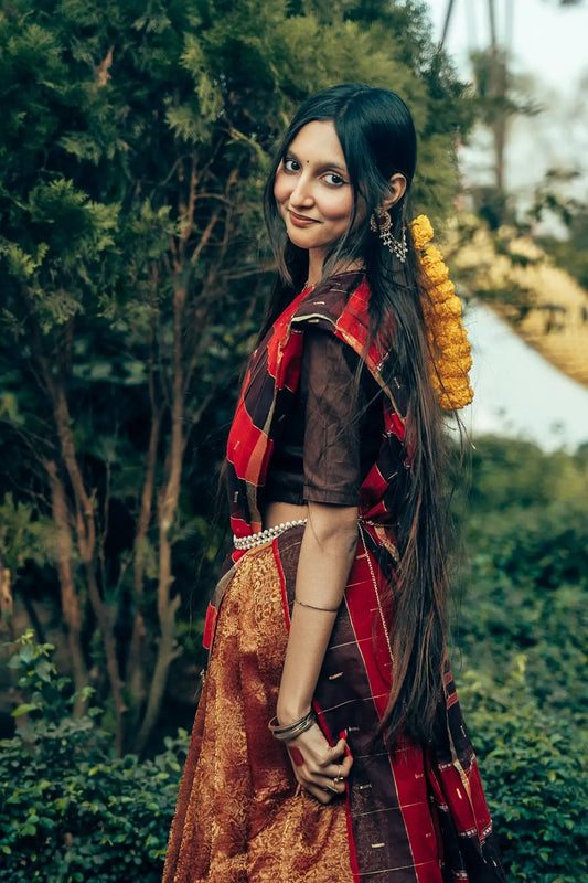 A woman in traditional indian attire smiles gently smiles.