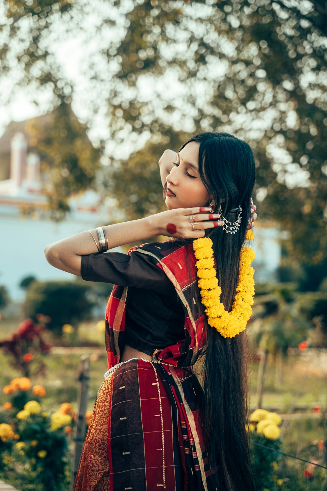 Woman in traditional indian attire with flower garland