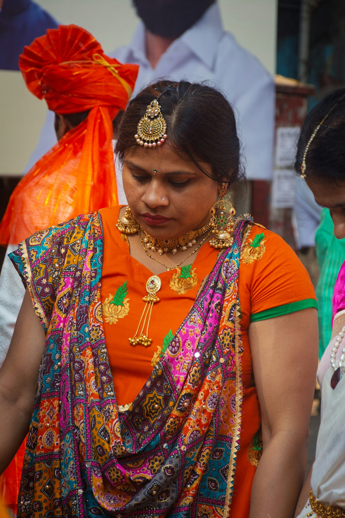 Woman in traditional indian attire with ornate jewelry.