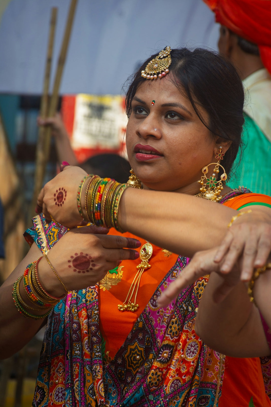 A woman in traditional indian attire dances with jewelry.