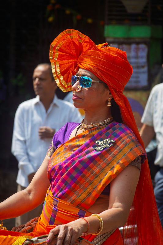Woman in traditional orange turban and sari