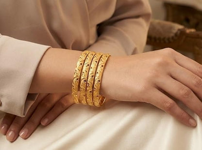 Close-up view of premium artificial Innovate Art Impex Traditional Bengali Gold Tone Alloy Bangle Set of 4 for Women | Intricate Cut-Out Leaf Pattern Ethnic Chudi Chura | Premium Anti-Tarnish Finish Shakha Pola Style Golden Bangles for Bridal Trousseau & Traditional Occasions by Innovate Art Impex.
