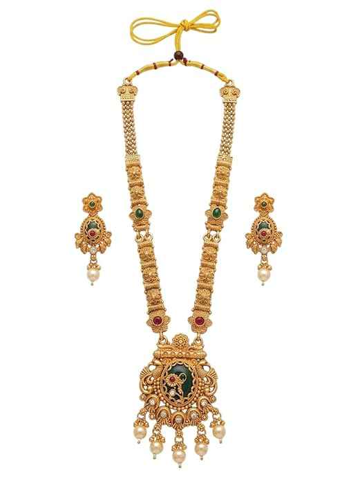 Close-up of INNOVATE ART IMPEX long temple haar necklace with matching stud earrings featuring green meenakari work, red stone accents, and pearl drops on a white background.