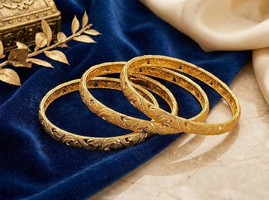 Close-up view of premium artificial Innovate Art Impex Traditional Bengali Gold Tone Alloy Bangle Set of 4 for Women | Intricate Cut-Out Leaf Pattern Ethnic Chudi Chura | Premium Anti-Tarnish Finish Shakha Pola Style Golden Bangles for Bridal Trousseau & Traditional Occasions by Innovate Art Impex.