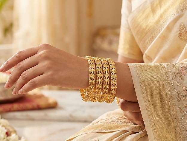 Close-up view of premium artificial Innovate Art Impex Traditional Bengali Golden Alloy Bangles Set of 4 for Women | Intricate Floral Filigree Cut-Out Ethnic Churi | Premium Artificial Gold Plated Bridal Wedding Jewelry | Festive Chudiya Pack for Girls by Innovate Art Impex.