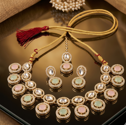 Ornate necklace and earrings set on a reflective surface