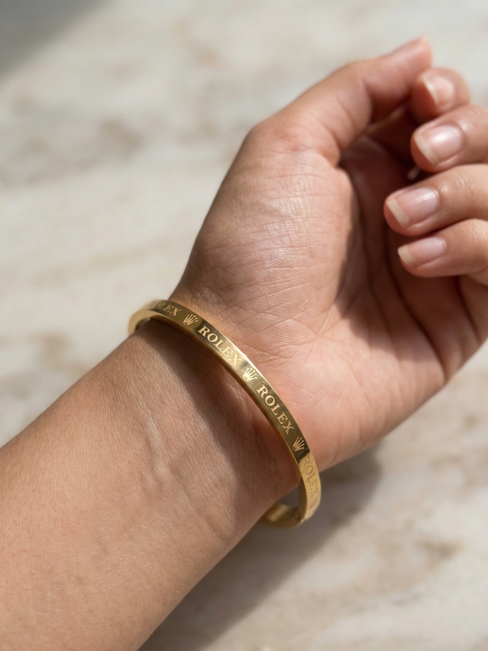 Close-up view of premium artificial Premium Gold-Plated Crown Engraved Bangle | Minimalist Designer Cuff Bracelet for Men & Women by Innovate Art Impex.