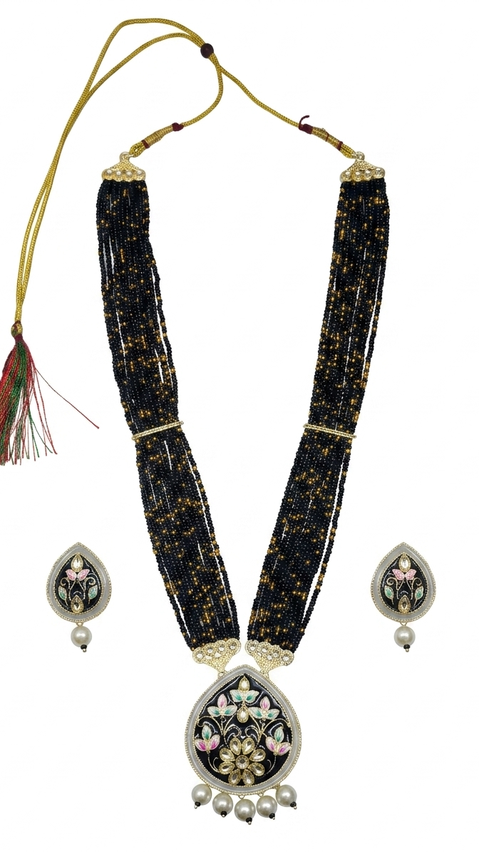 Black beaded necklace with silver floral pendants on a white background