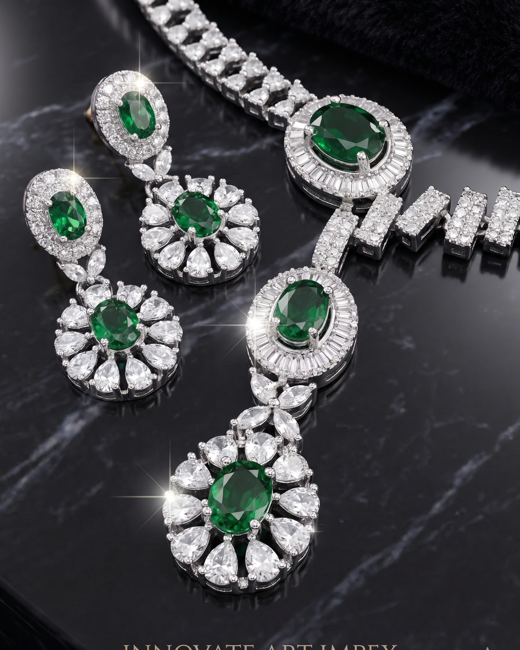 Jewelry set with emerald and diamond earrings and necklace on a dark background
