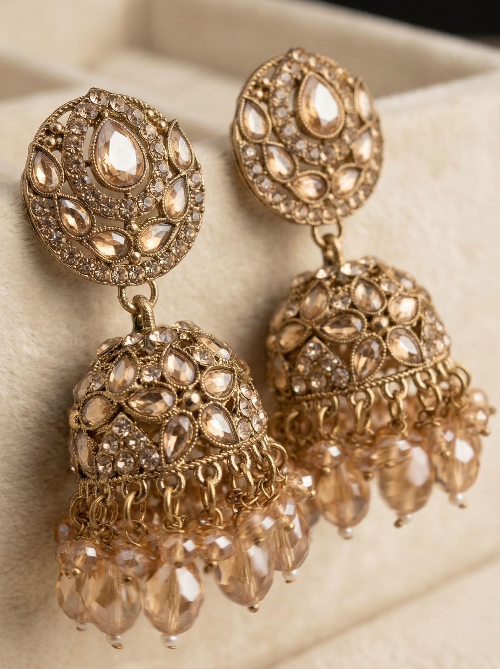 Close-up view of premium artificial Antique Gold Floral Leaf Design Jhumki Earrings with Handcrafted Bead Drops. by Innovate Art Impex.