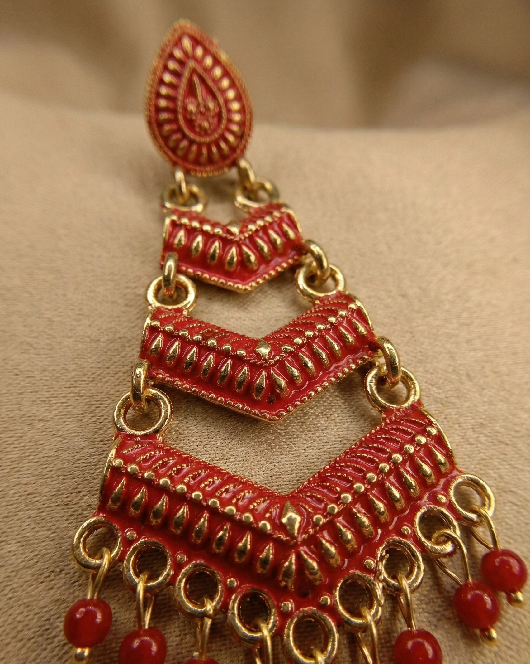 Close-up view of premium artificial Red Meenakari Gold Plated Layered Drop Earrings with Pearl Hanging by Innovate Art Impex.