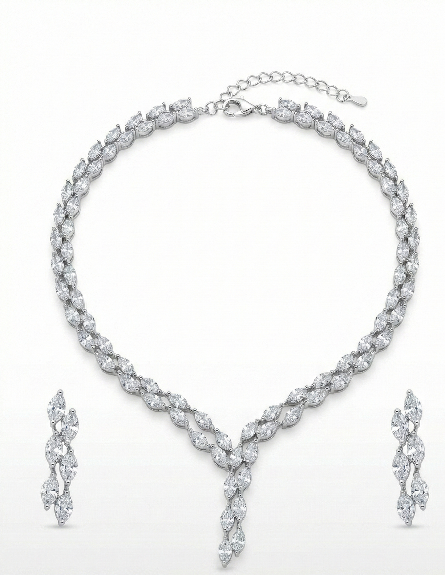 Close-up view of premium artificial Silver plated American Diamond marquise necklace and earring set on white by Innovate Art Impex.