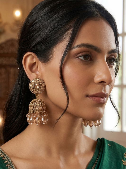 Close-up view of premium artificial Traditional Gold-Plated Round Stud Jhumka Earrings with Champagne Crystal Drops for Women. by Innovate Art Impex.