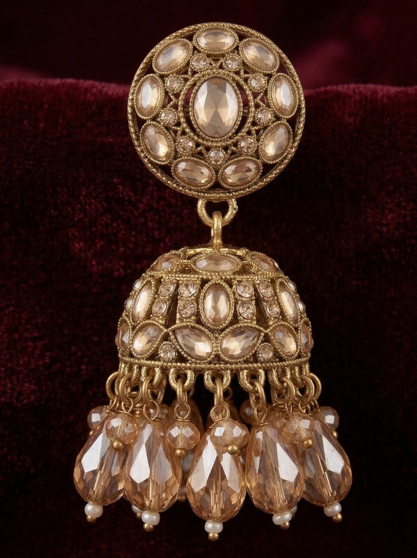 Close-up view of premium artificial Traditional Gold-Plated Round Stud Jhumka Earrings with Champagne Crystal Drops for Women. by Innovate Art Impex.
