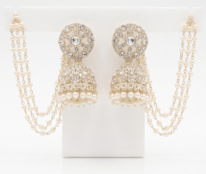 Pair of gold and pearl earrings with chains on a white background