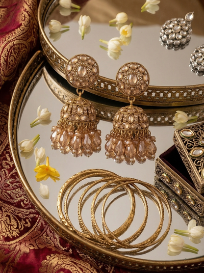 Close-up view of premium artificial Traditional Gold-Plated Round Stud Jhumka Earrings with Champagne Crystal Drops for Women. by Innovate Art Impex.