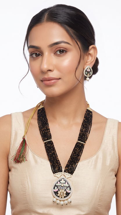 Woman wearing a traditional necklace and earrings on a white background