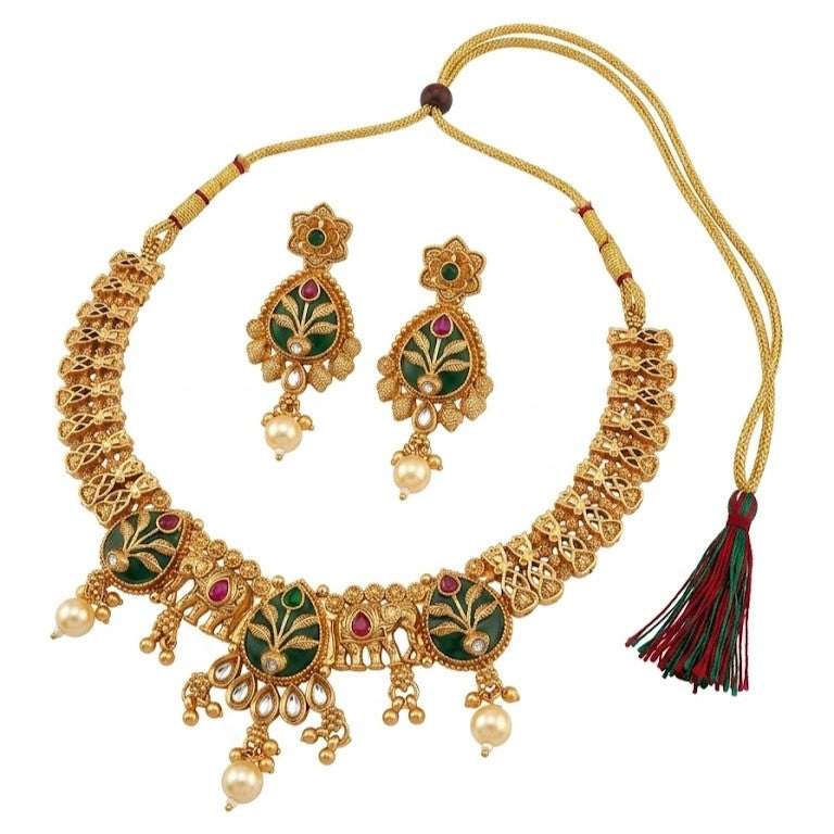 Gold necklace with green and red accents and matching earrings on a white background