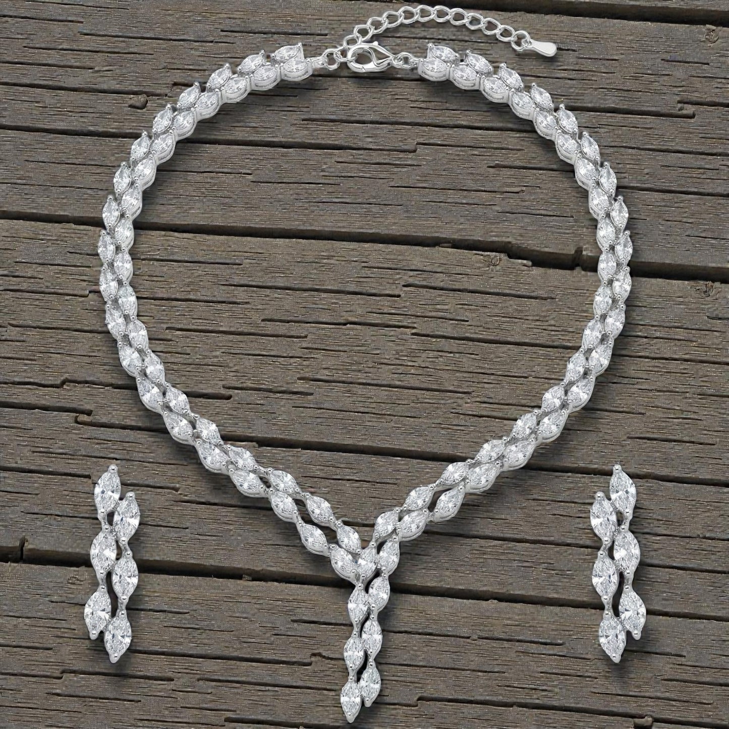 Close-up view of premium artificial Silver plated American Diamond marquise necklace and earring set on white by Innovate Art Impex.
