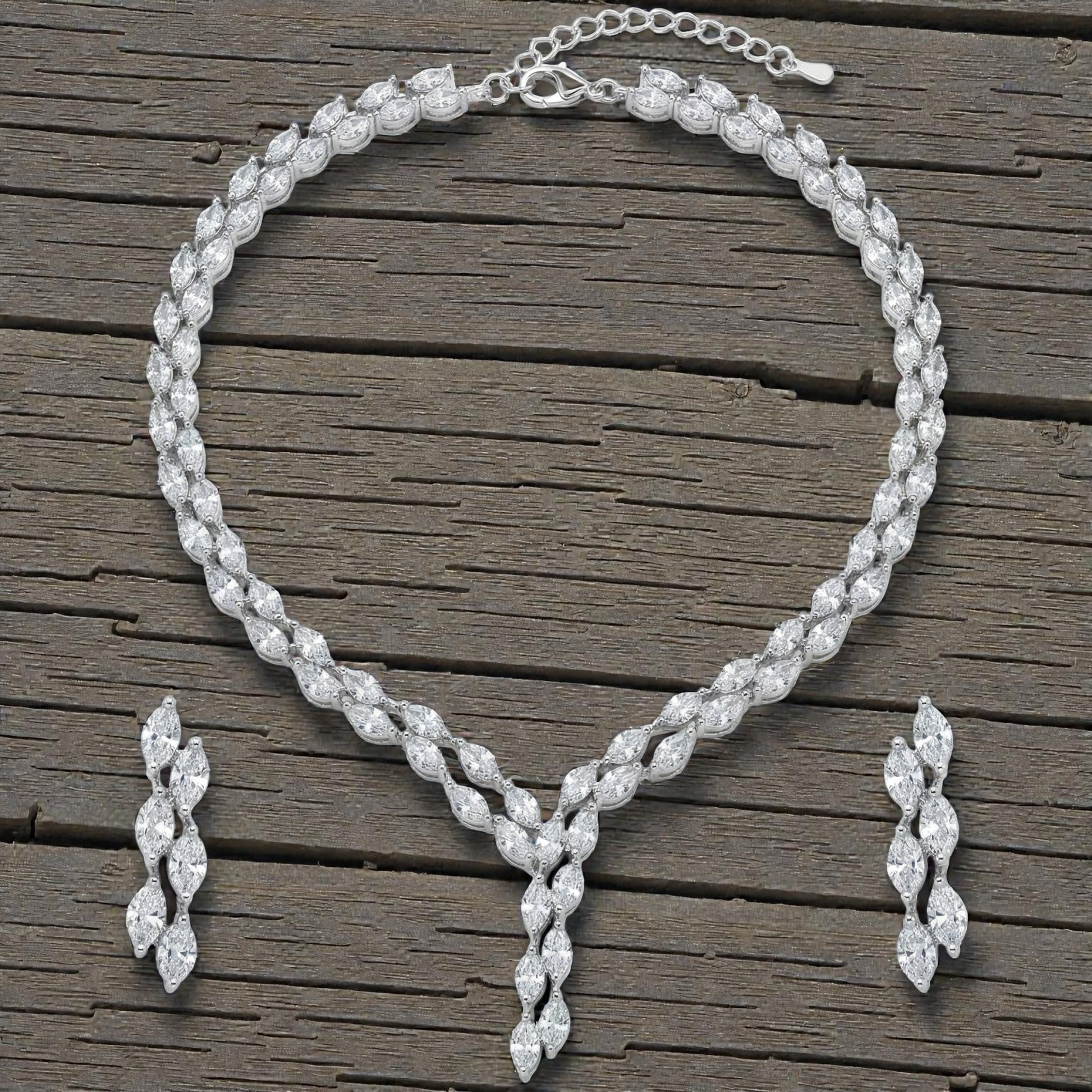 Close-up view of premium artificial Silver plated American Diamond marquise necklace and earring set on white by Innovate Art Impex.