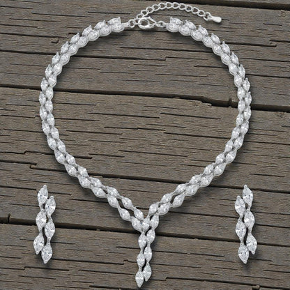 Close-up view of premium artificial Silver plated American Diamond marquise necklace and earring set on white by Innovate Art Impex.