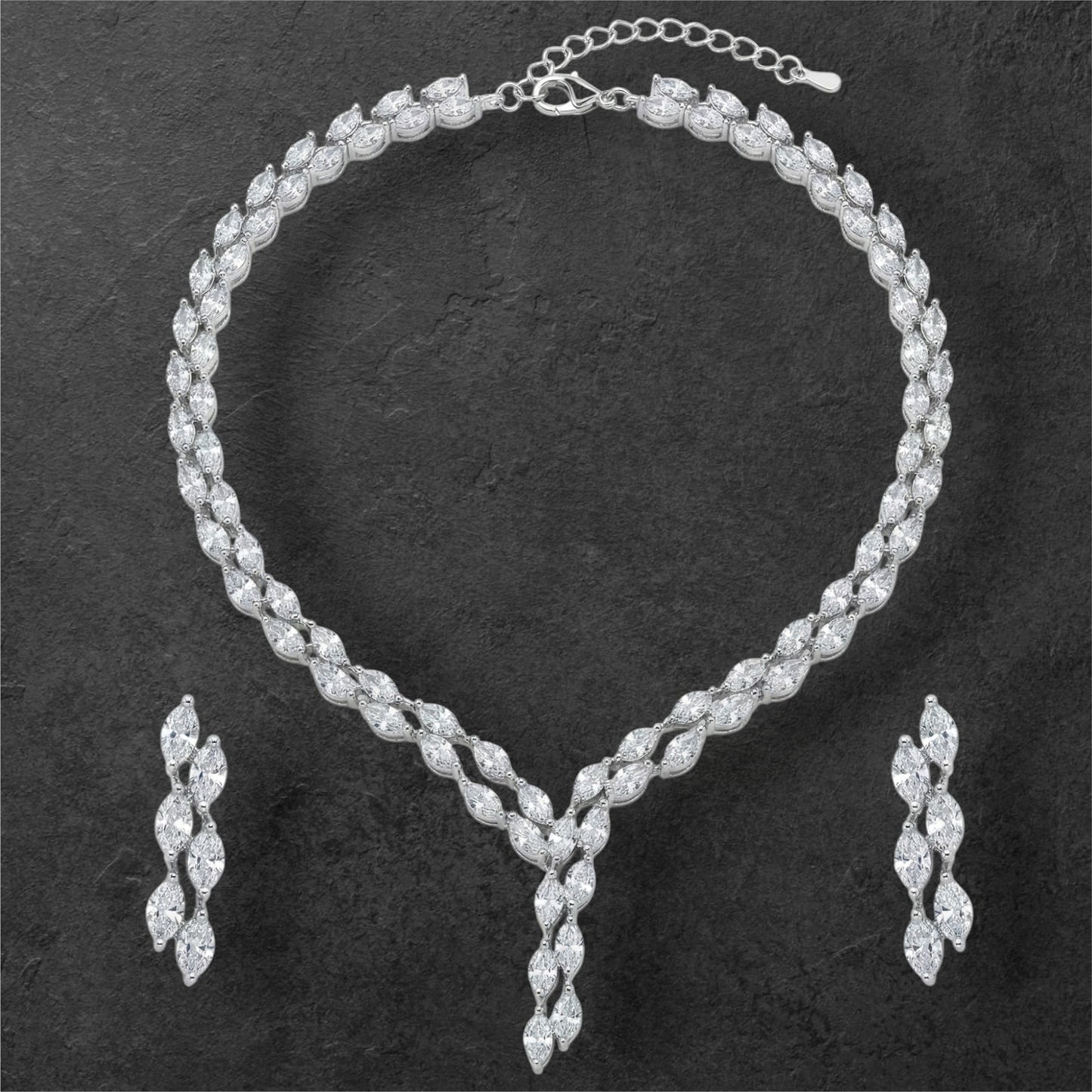 Close-up view of premium artificial Silver plated American Diamond marquise necklace and earring set on white by Innovate Art Impex.