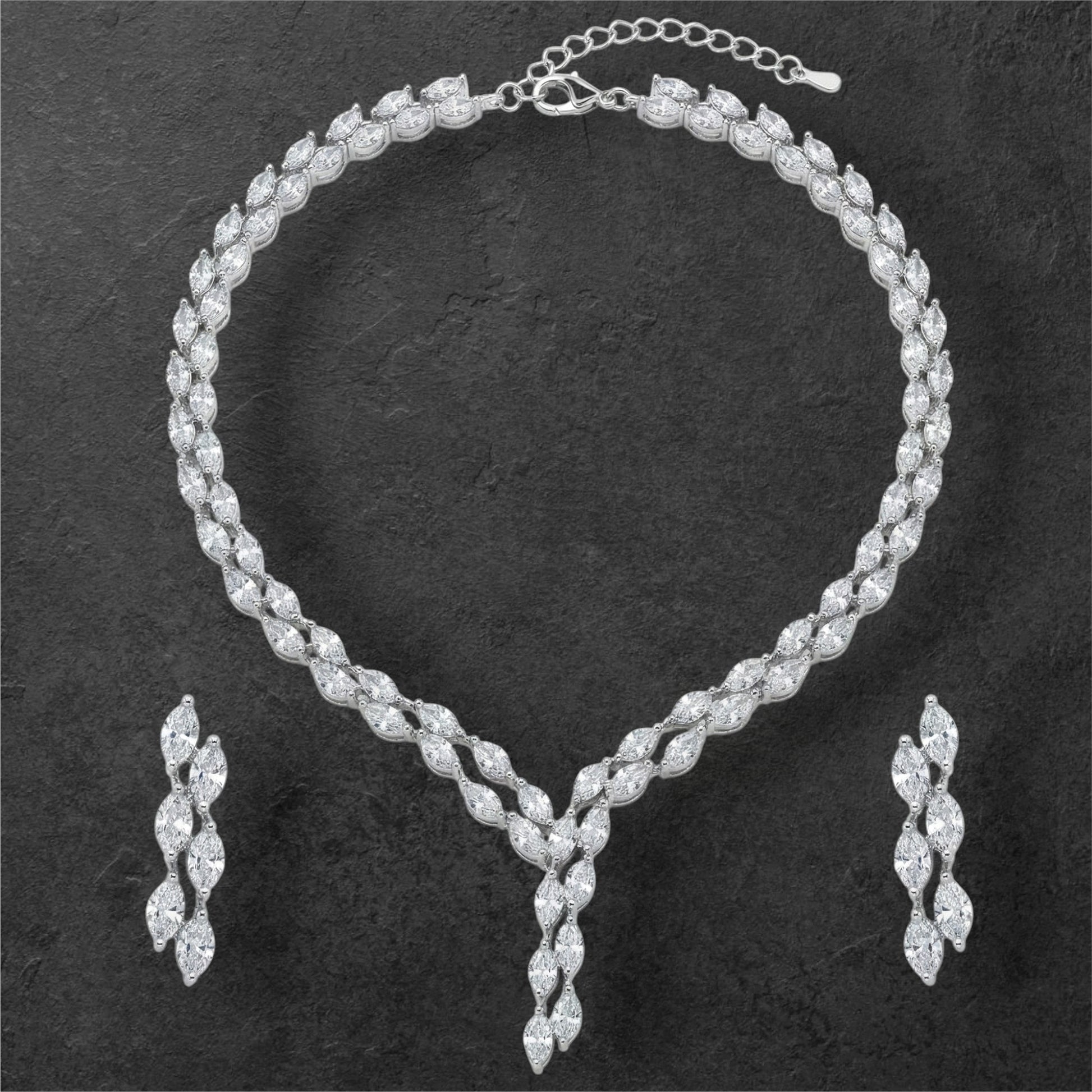 Close-up view of premium artificial Silver plated American Diamond marquise necklace and earring set on white by Innovate Art Impex.