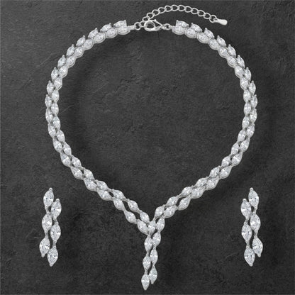 Close-up view of premium artificial Silver plated American Diamond marquise necklace and earring set on white by Innovate Art Impex.