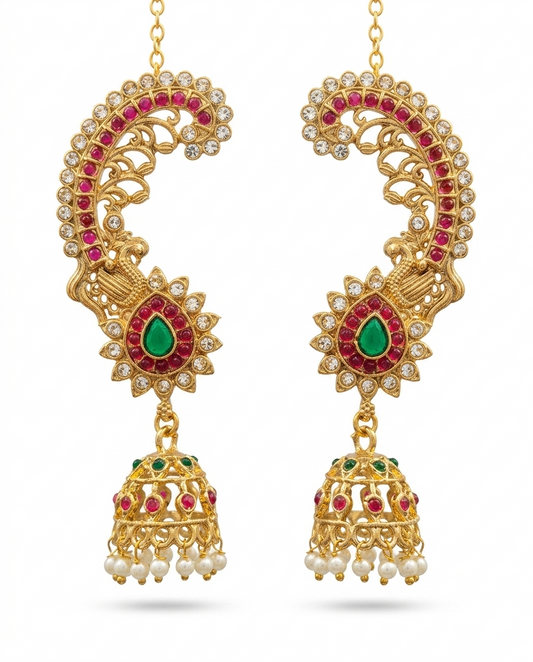 Pair of INNOVATE ART IMPEX antique gold peacock ear cuff kaan chain jhumkas with red and green stones on a clean white background.