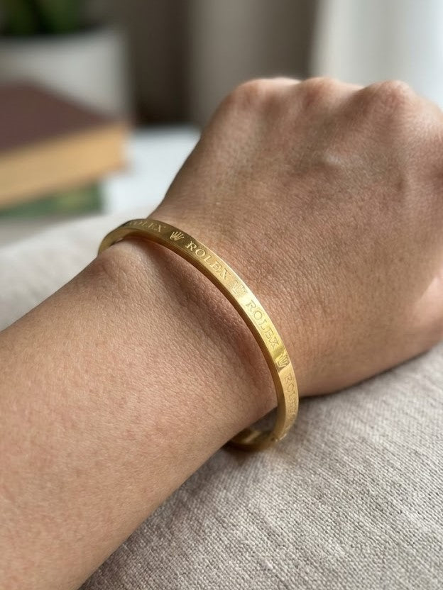 Close-up view of premium artificial Premium Gold-Plated Crown Engraved Bangle | Minimalist Designer Cuff Bracelet for Men & Women by Innovate Art Impex.